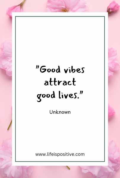 A rectangular card with a white background and slim green border contains the quote “Good vibes attract good lives” attributed to "Unknown" in black text. The card is framed by pink flowers on a light pink background, with "www.lifeispositive.com" at the bottom. Find more quotes-on-positive-energy-2 here.