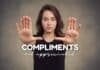 A young woman with long brown hair stands, facing the camera with a neutral expression. She holds both hands up, palms outward in a stopping gesture. The text overlay reads "Compliments-for-women not appreciated.