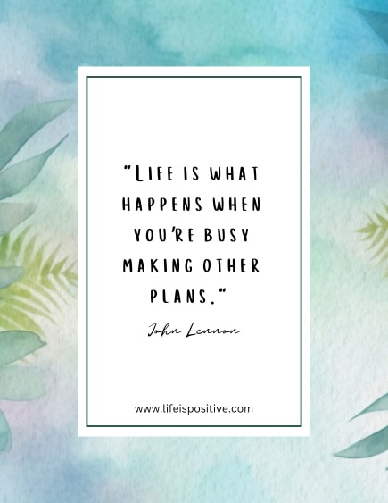 An inspirational quote on a watercolor background with light blue and green hues and leafy patterns reads, "Life is what happens when you're busy making other plans." Attributed to John Lennon, this deep quote about life reminds us to live in the moment. Below, the website "www.lifeispositive.com" is mentioned.