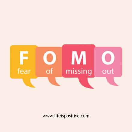 Colorful speech bubbles spell out "FOMO," with each letter in a separate bubble, explaining "what-is-fomo-fear-of-missing-out." The bubbles are colored yellow, orange, red, and pink from left to right on a light beige background. At the bottom is the site "www.lifeispositive.com.